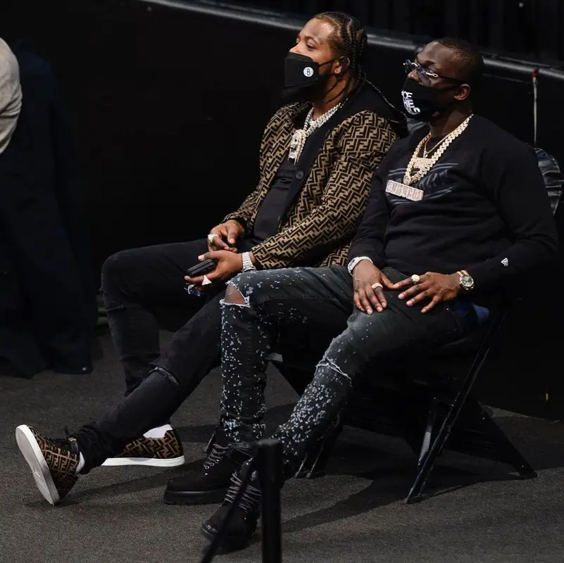 Bobby Shmurda outfit in New Era, Amiri, and Louis Vuitton, 2021