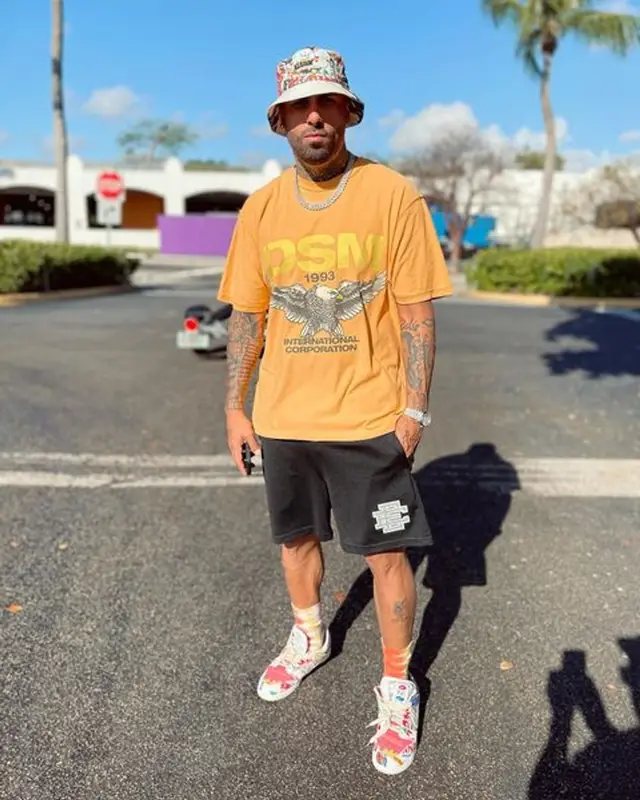 Nicky Jam outfit in Eric Emanuel, XLARGE, and Stussy, 2021