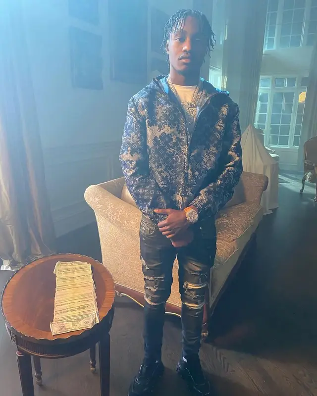 Lil Tjay outfit in Louis Vuitton, Amiri, and Prada, 2021