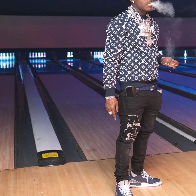 DaBaby outfit in Louis Vuitton, Amiri, and New Era, 2021