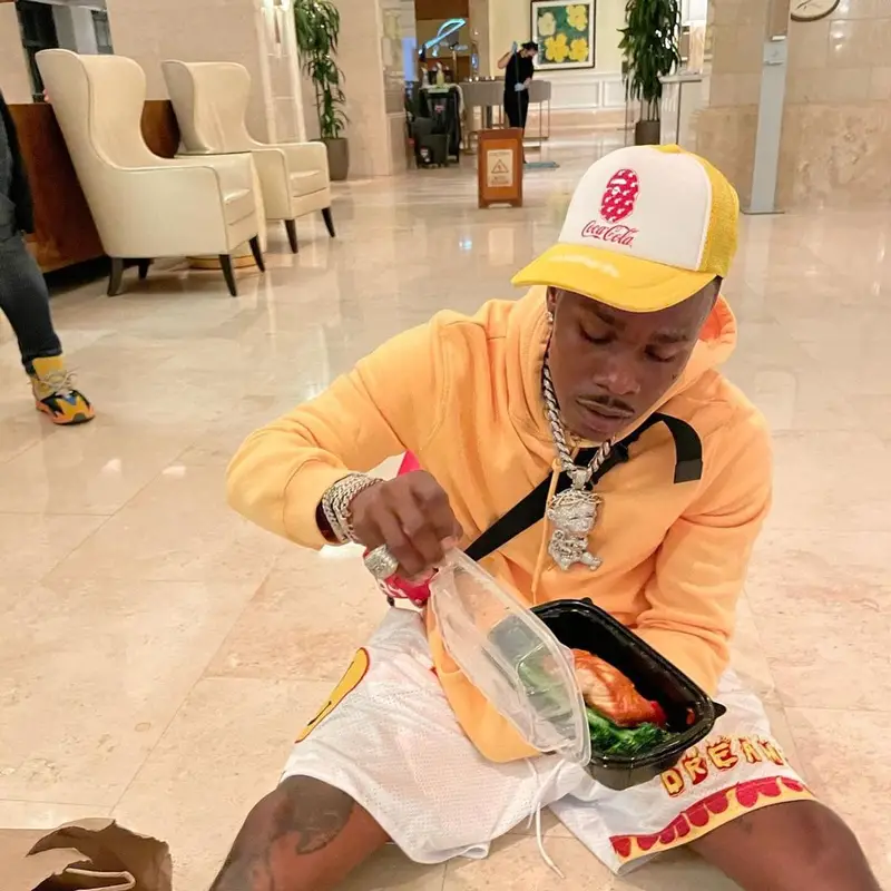 DaBaby outfit in Burberry, Bape, and Coca-Cola, 2021