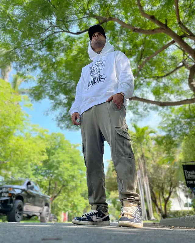 Nicky Jam outfit in Dior, Palm Angels, and Shawn, 2021