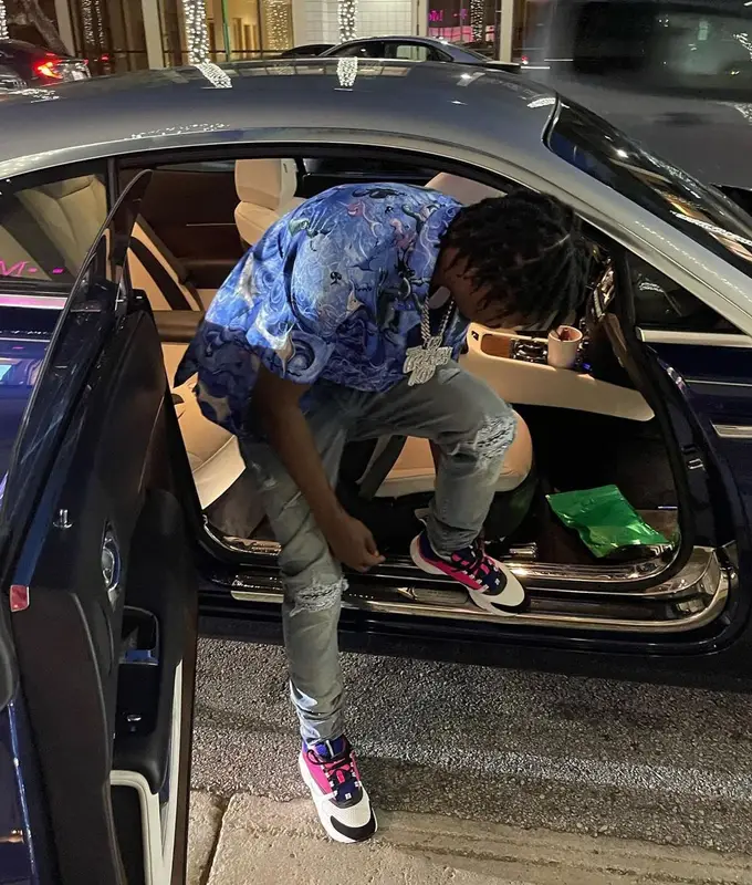 Lil Tjay outfit in Dior, Amiri, and Kenny Scharf, 2021