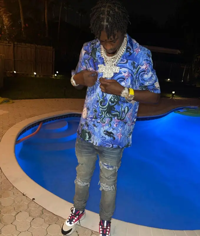 Lil Tjay outfit in Dior, Amiri, and Kenny Scharf, 2021