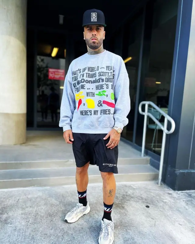 Nicky Jam outfit in Travis Scott Merch, Givenchy, and McDonald's Merch, 2021