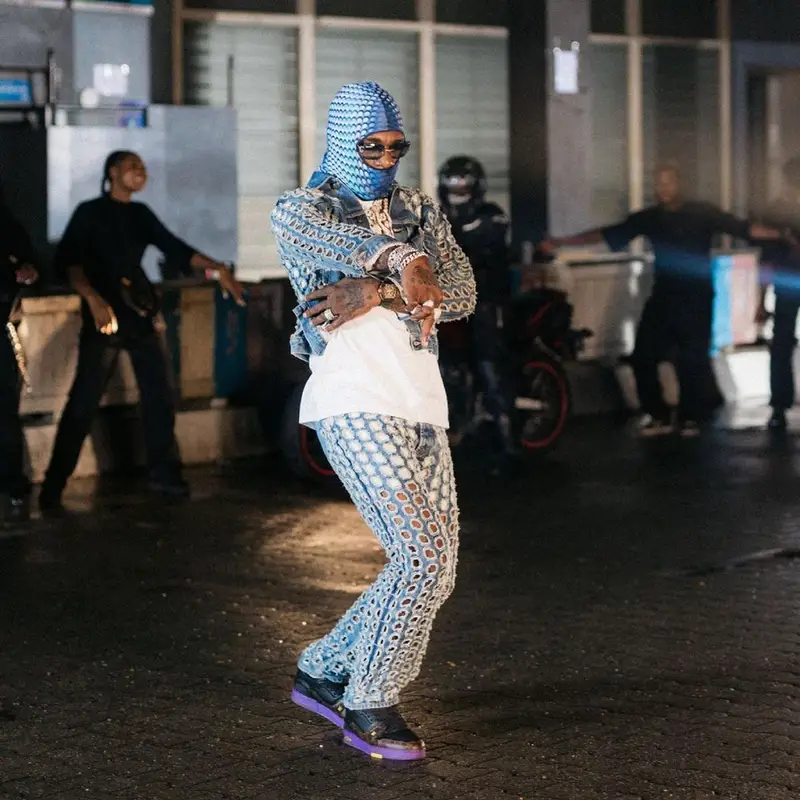 Burna Boy outfit in Maison Margiela, Louis Vuitton, and Marine Serre, 2021