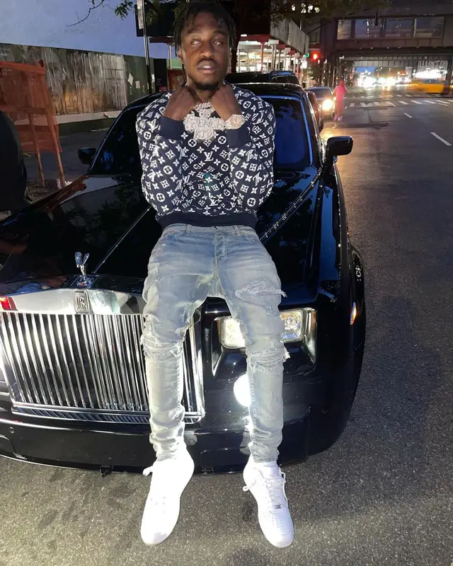 Lil Tjay outfit in Louis Vuitton, Amiri, and Nike, 2021