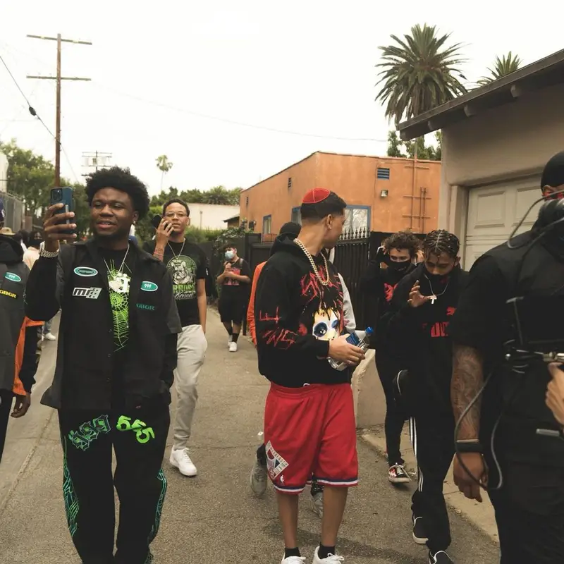 Lil Bibby outfit in Vlone, Mitchell & Ness, and Juice Wrld Merch, 2021