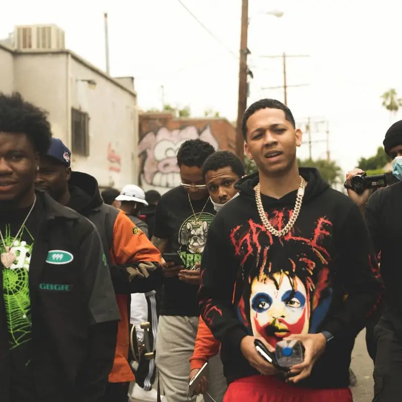 Lil Bibby outfit in Vlone, Mitchell & Ness, and Juice Wrld Merch, 2021
