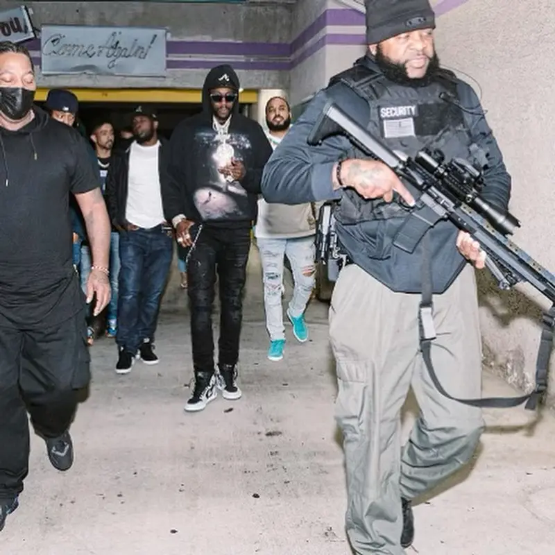 2 Chainz outfit in Amiri, Louis Vuitton, and New Era, 2021