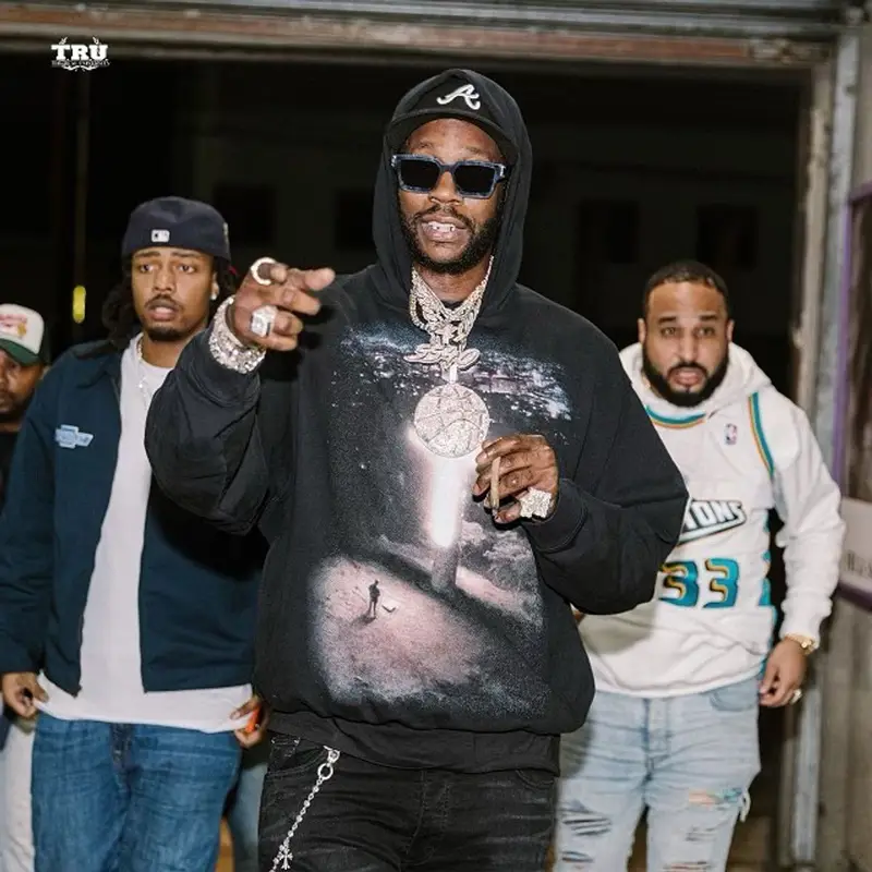 2 Chainz outfit in Amiri, Louis Vuitton, and New Era, 2021