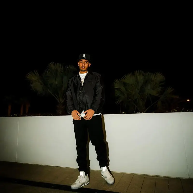 Myke Towers outfit in Prada, Jordan, and New Era, 2021