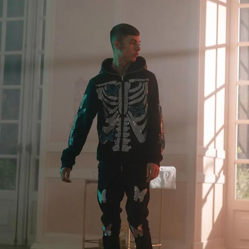 Natanael Cano outfit in Outsiderz, Nike, and Travis Scott Merch, 2021