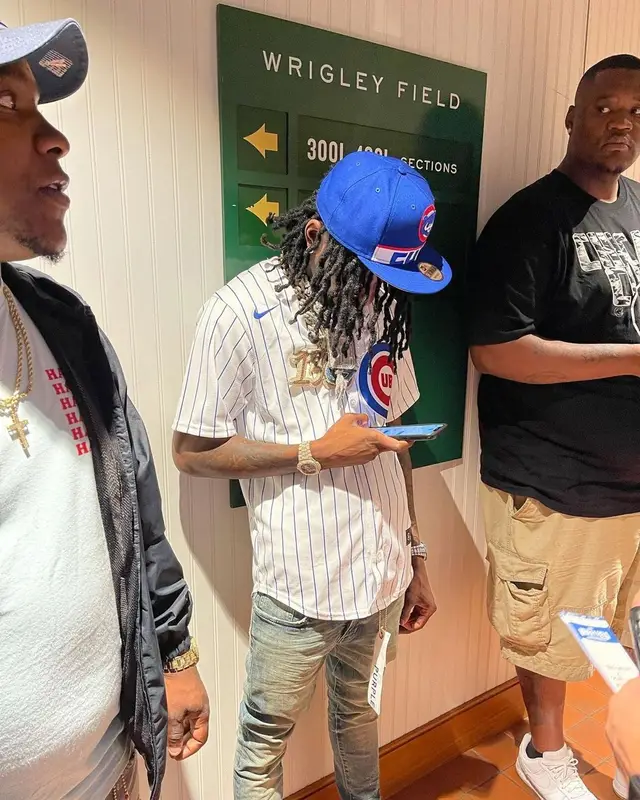 Polo G outfit in Nike, Purple Brand, and Rawlings, 2021