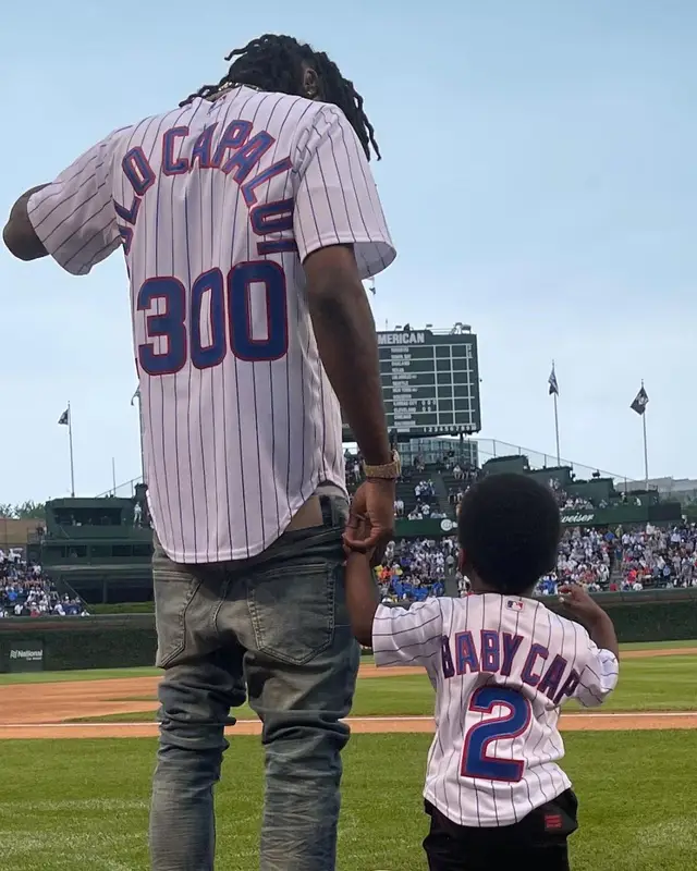 Polo G outfit in Nike, Purple Brand, and Rawlings, 2021