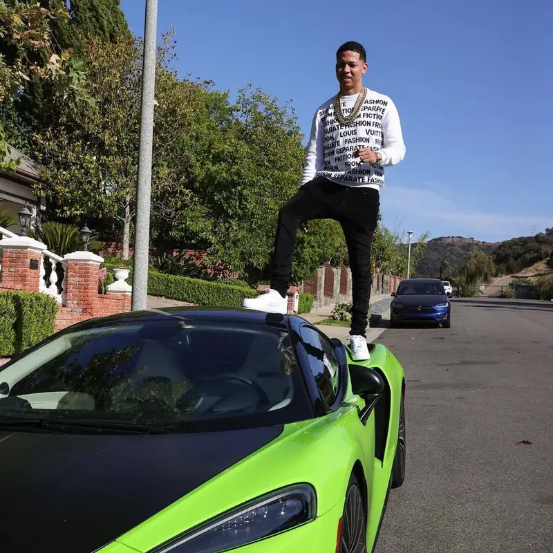 Lil Bibby outfit in Louis Vuitton, Amiri, and Nike, 2021