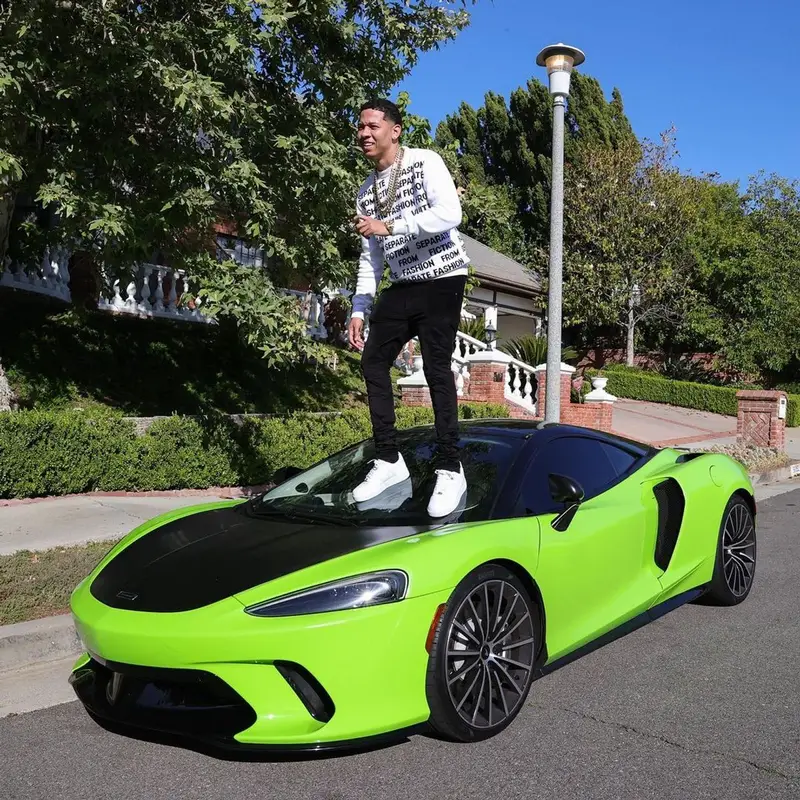 Lil Bibby outfit in Louis Vuitton, Amiri, and Nike, 2021