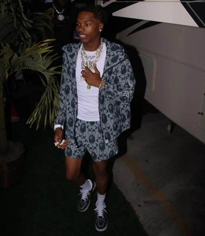 Lil Baby outfit in Bape, Polo Ralph Lauren, and Coach, 2021