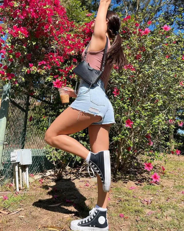 Charli D'Amelio outfit in Skims, Converse, and Louis Vuitton, 2021