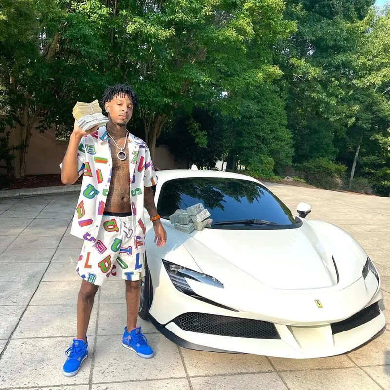21 Savage outfit in Louis Vuitton, NBA, and Hanes, 2021