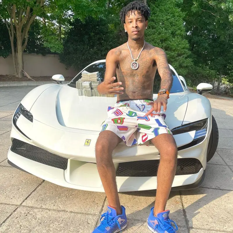 21 Savage outfit in Louis Vuitton, NBA, and Hanes, 2021
