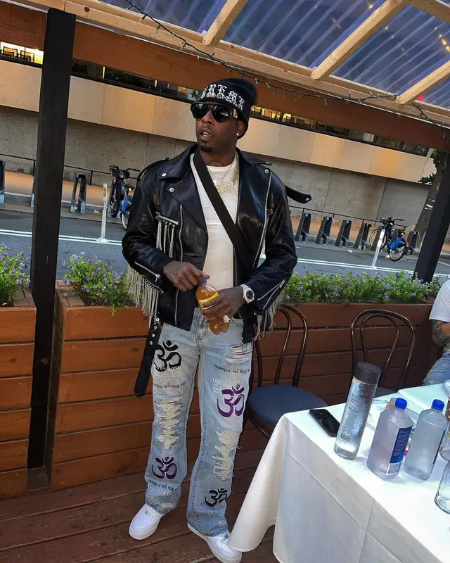 Lil Duke outfit in What Happened To God, Versace, and Supreme, 2021