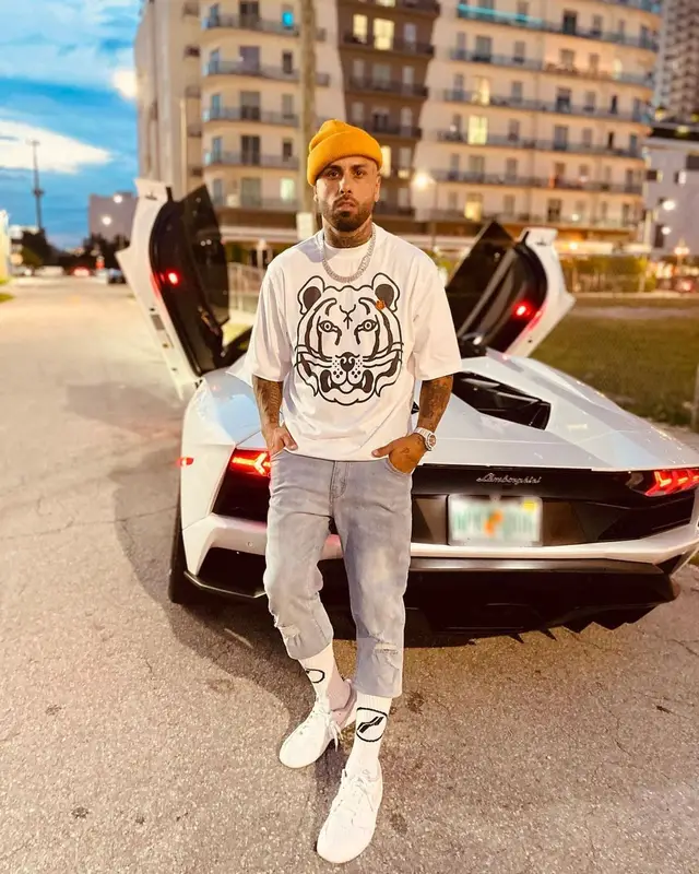 Nicky Jam outfit in Kenzo, Nike, and We11done, 2021