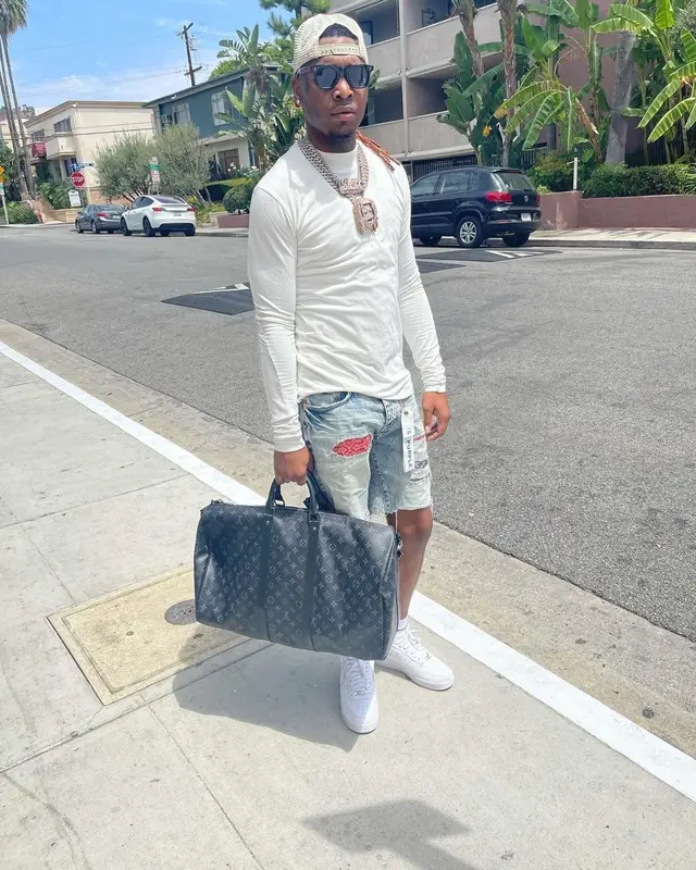 Lil Keed outfit in Purple Brand, Louis Vuitton, and Gucci, 2021