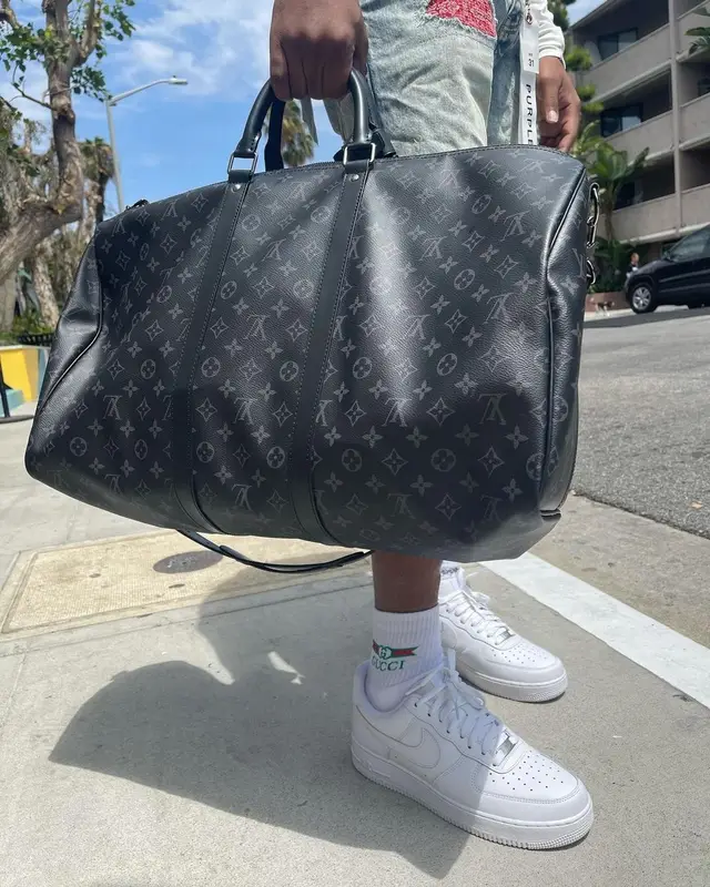 Lil Keed outfit in Purple Brand, Louis Vuitton, and Gucci, 2021