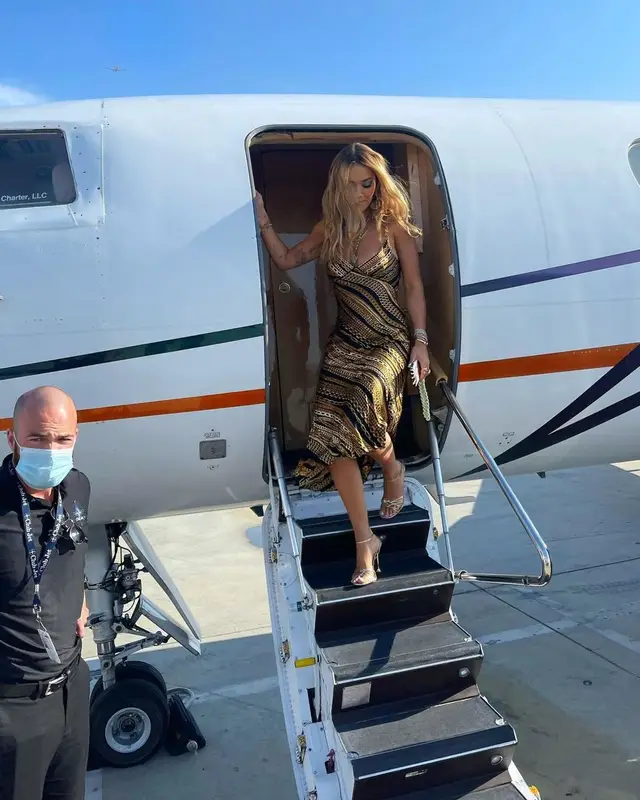 Rita Ora outfit in Chanel, Roberto Cavalli, and Carvela, 2021