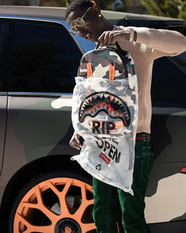Young Dolph outfit in Sprayground, Gucci, and Young Dolph Merch, 2021