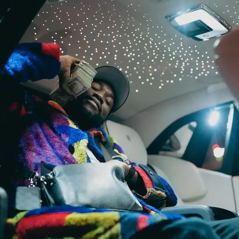 Meek Mill outfit in Sacai, Louis Vuitton, and   Kaws, 2021