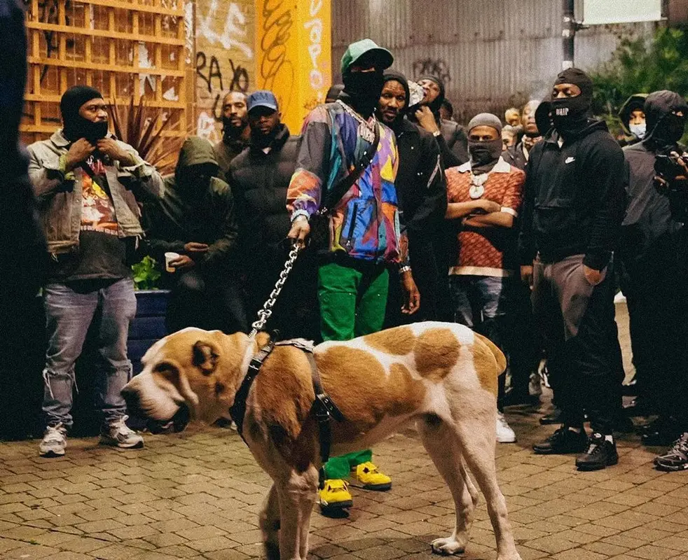 Meek Mill outfit in Sacai, Louis Vuitton, and   Kaws, 2021