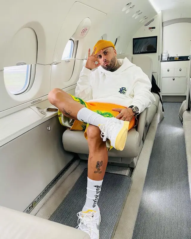 Nicky Jam outfit in Eric Emanuel, Nike, and Palm Angels, 2021
