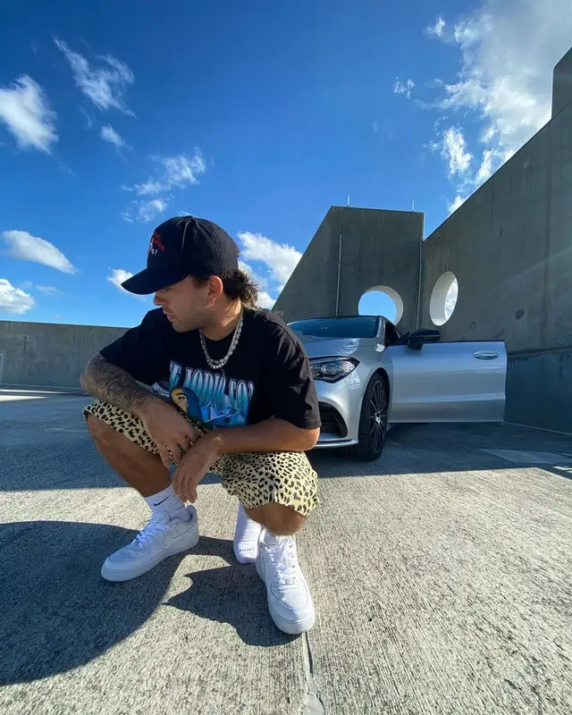 Feid outfit in Karol G Merch, Supreme, and Nike, 2021