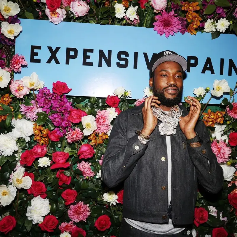 Meek Mill outfit in Louis Vuitton, Nike, and New Era, 2021