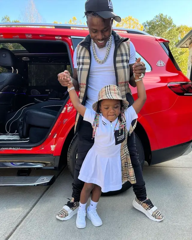 DaBaby outfit in Burberry, Hanes, and New Era, 2021