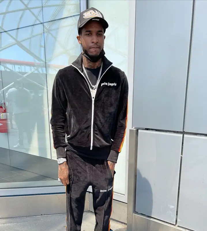 Lil Reese outfit in Palm Angels, Bape, and Von Dutch, 2021