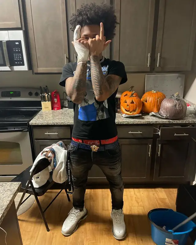 Mikey outfit in Vlone, Versace, and Pop Smoke Merch, 2021
