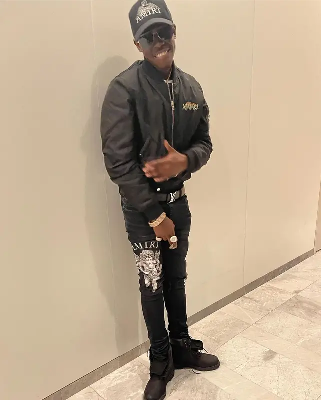 Bobby Shmurda outfit in Louis Vuitton, Dior, and Amiri, 2021