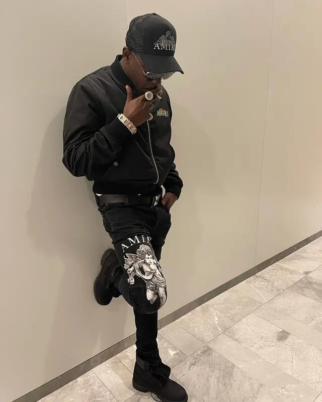 Bobby Shmurda outfit in Louis Vuitton, Dior, and Amiri, 2021