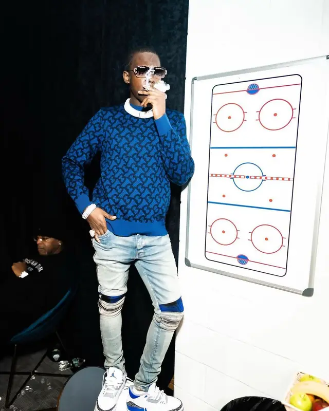 Bobby Shmurda outfit in Burberry, Amiri, and Louis Vuitton, 2021