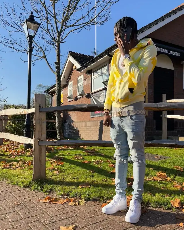 Russ Millions outfit in Bape, Amiri, and Louis Vuitton, 2021