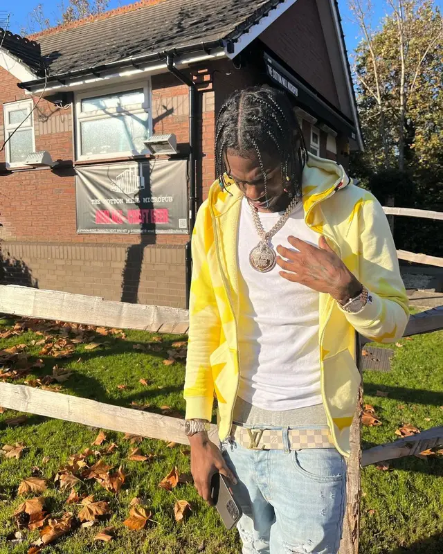 Russ Millions outfit in Bape, Amiri, and Louis Vuitton, 2021