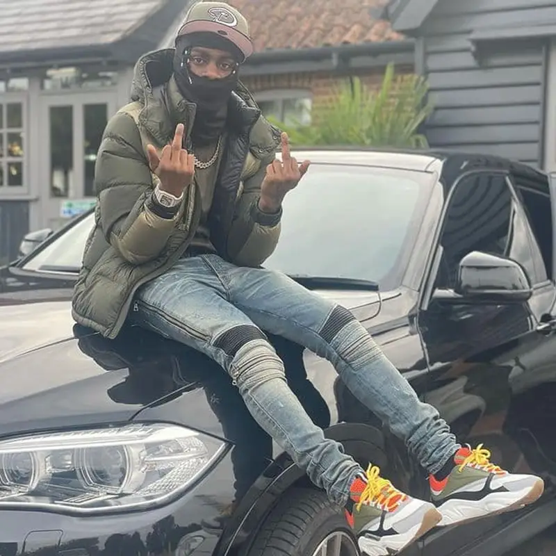 Russ Millions outfit in Amiri, Dior, and New Era, 2021