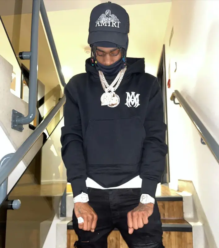 Russ Millions outfit in Prada, Louis Vuitton, and Amiri, 2021