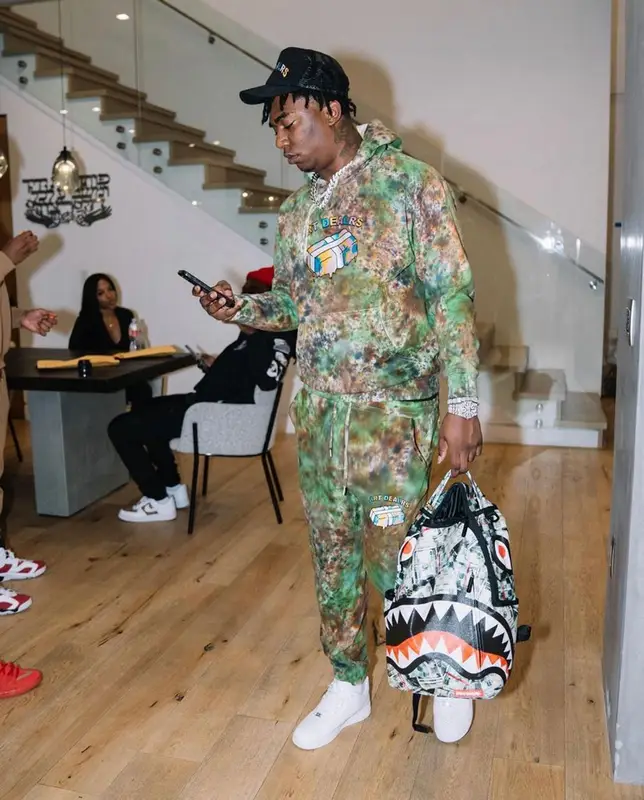 Fredo Bang outfit in The Art Dealrs, Nike, and Sprayground, 2021