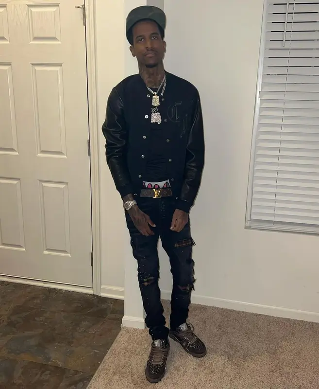 Lil Reese outfit in Amiri, Louis Vuitton, and Chrome Hearts, 2022