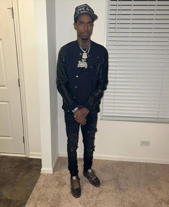 Lil Reese outfit in Amiri, Louis Vuitton, and Chrome Hearts, 2022
