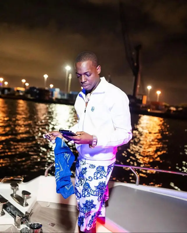 Bobby Shmurda outfit in Dior, Kenny Scharf, and Nike, 2022
